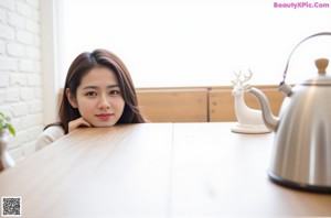 A woman in a white shirt is sitting in a bathtub.