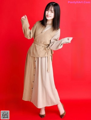 A woman with long black hair and bangs posing for a picture.