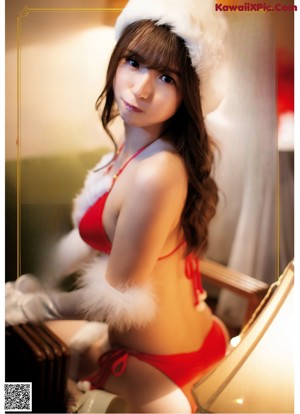 A woman in a santa hat is posing for a picture.