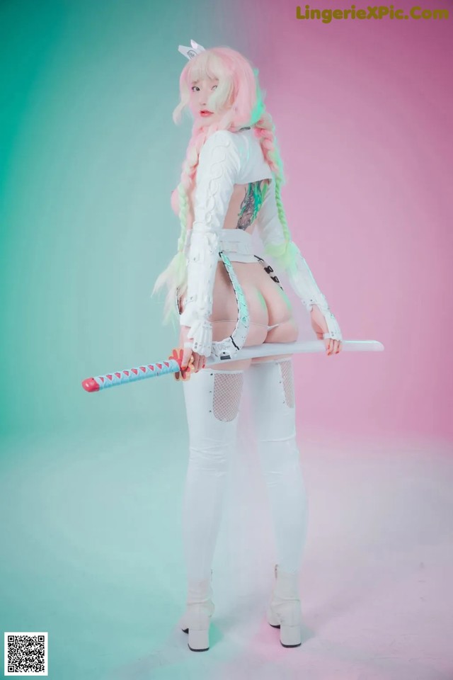 A woman in a white outfit holding a sword.