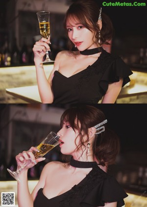 A woman sitting at a table with wine glasses.