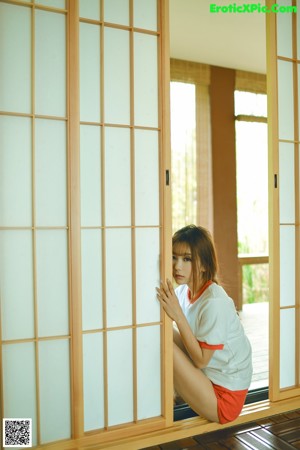 A woman in a school uniform posing for a picture.