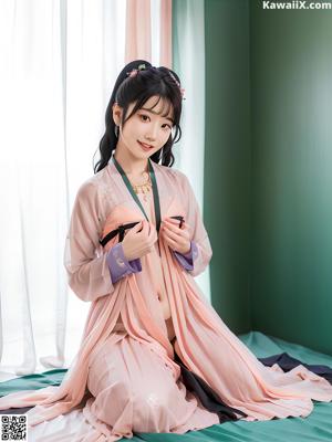 a woman in a blue and yellow hanbob sitting on a bed