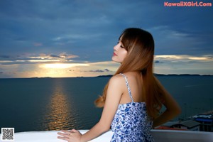 A naked asian woman sitting on top of a chair.