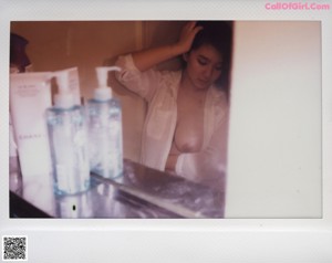 A naked woman laying on a bed with her back to the camera.
