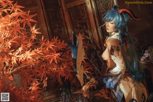 A woman with blue hair sitting on the floor next to a lamp.