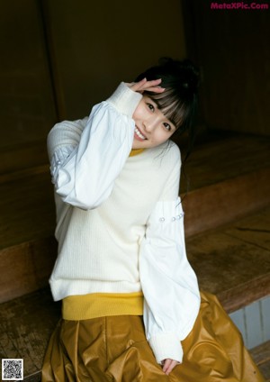 A magazine with a young woman wearing a scarf.