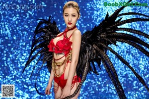 A woman in a black lingerie posing for the camera.