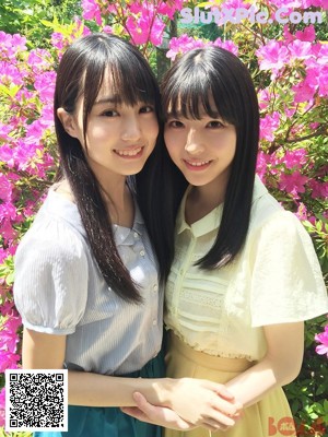 A couple of young women standing next to each other.